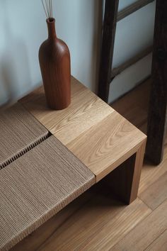 a vase sitting on top of a wooden table