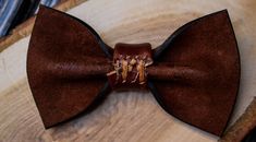 "Leather Bow Tie - an accessory that gives an opportunity to play with style, change its appearance, be fashionable, extravagant, presentable. Minimalist design, unisex. Bow tie made of 100% mat genuine cowhide leather (calf leather) made in Italy. Size: - 6x11 cm. (2.3x4.3\") - strap is regulated; - the width of strap is 1.5 cm. (3/4\"). It is very comfortable to use. Color on photo: Brown It is a unique accessory to have a perfect outfit on the entertainment, or on the stag party or in everyda Luxury Bow Tie As Gift, Brown Bow Tie For Father's Day Gift, Dapper Butterfly Knot Bow As Gift, Dapper Decorative Bow Tie As Gift, Dapper Bow Tie With Decorative Bow For Gifts, Dapper Bow Tie With Detachable Bow As Gift, Dapper Bow Tie As A Gift, Dapper Detachable Bow Tie As Gift, Brown Bow Tie For Wedding