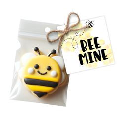 a cookie in the shape of a bee with a tag on it's side