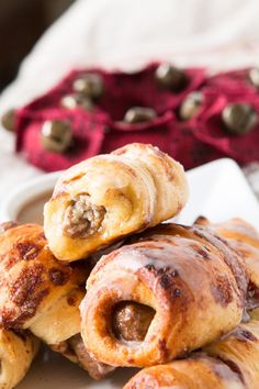 several pastries are piled on top of each other in a white plate with red napkins