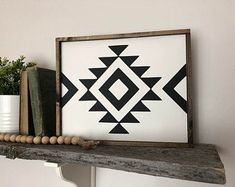 a black and white geometric print on a shelf