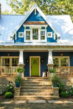 a blue and white house with steps leading up to the front door