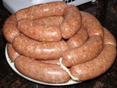 there are many sausages stacked on top of each other in the bowl and ready to be cooked