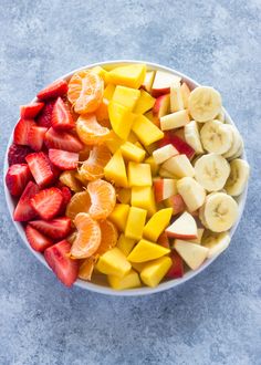 a white bowl filled with sliced fruit on top of a table