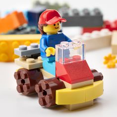 a lego man driving a toy car made out of legos and other building blocks