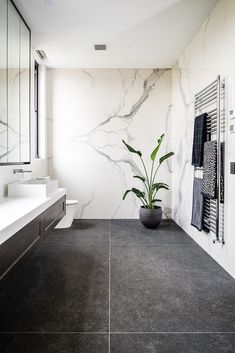 a large bathroom with black and white tile flooring