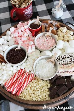 a platter filled with marshmallows, candy canes and other treats