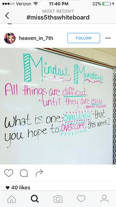 a white board with writing on it in front of a black and white striped wall