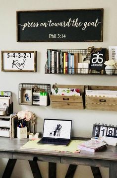 a desk with two laptops on it next to some books and other items in baskets