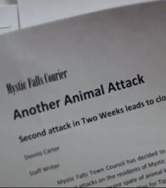 a close up of a paper with an animal attack written on the front and back