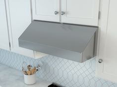 a stove top oven sitting inside of a kitchen next to wooden utensils on a counter