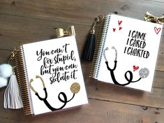 two notebooks with writing on them sitting next to each other, one has a stethoscope and the other has a tassel