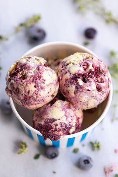 blueberry muffins in a paper cup on a table with fresh blueberries