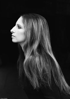 a black and white photo of a woman with long hair looking off to the side