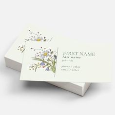 two business cards with flowers on them