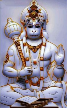 an image of the god in white with gold accents on his face and hands, sitting next to a book