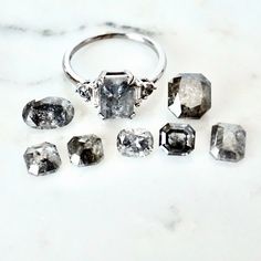 an assortment of diamonds sitting on top of a white marble countertop next to each other