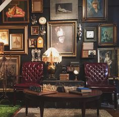 a living room filled with furniture and pictures on the wall