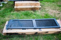 a grill sitting on top of a box in the grass