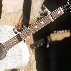 a close up of a person holding a guitar