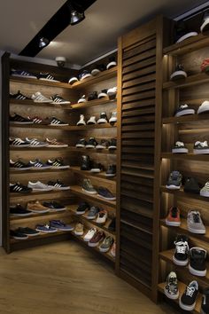 there are many pairs of shoes on the shelves