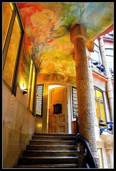 a staircase leading up to a painting on the ceiling