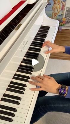 two people are sitting at a piano and playing music on the keyboard with their hands