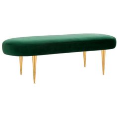 an upholstered bench with gold legs and a green velvet cover on the top