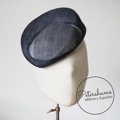 Betty is what we like to call a modern pillbox. Instead of having straight sides, this french navy hat base has a gentle slope to one side and finishes off at a slight point. It looks great positioned at many angles and is finished on the inside with a petersham ribbon edge. Can be attached to the head with elastic, hair comb or headband (not included).Measurements:Width: 16.5x18.5cm (6.4x7.2 inches)Height at tallest ridge: 5.5cm (2.1 inches)We have hundreds of different hat bases available! To Navy Fitted Hat With Short Brim, Navy Formal Hat With Curved Brim, Navy Curved Brim Formal Hat, Elastic Hair Comb, Sinamay Fascinator, Blank Hats, Navy Hat, Millinery Supplies, Hat Base