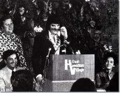 an old black and white photo of people at a podium