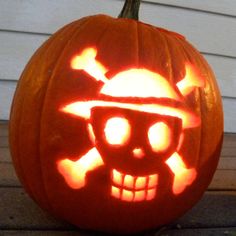 a pumpkin carved to look like a skull wearing a hat