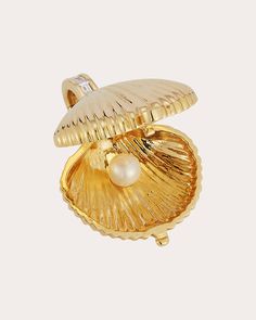 A love letter to the sea, this shell-shaped locket opens to reveal a gleaming white pearl and engraved seahorse motif. The 18-karat gold charm shimmers with baguette-cut diamonds along the bail and a single bezel-set stone at the base. Chain not included Retractable bail with safety clasp Hinge opening 18k yellow gold, pearl and diamond Diamond carat: 0.09 ctw Diamond color: H Diamond clarity: SI Diamond cut: baguette Polish with soft cloth Made in Thailand If you would like to consult with a fine jewelry expert, please email us at jewelryconcierge@olivela.com. Measurements Length: 0.75in Elegant Shell Pendant As Gift, Elegant Shell Pendant As A Gift, Elegant Shell Pendant For Gift, Luxury Shell-shaped Jewelry Gift, Elegant Gold Shell As Gift, Elegant Gold Shell With Pearl Charm, Pearl Locket, A Love Letter, Locket Charms