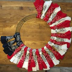 a wreath made out of red, white and blue fabric