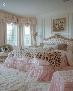 a bedroom decorated in pink and white with leopard print on the bed