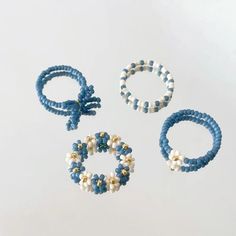 three bracelets, one with pearls and the other with beads