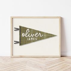 a wooden framed sign with the words oliver james on it in front of a white wall