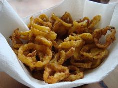 some fried food is in a basket on a table