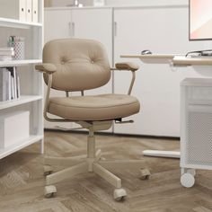 an office chair sitting in front of a computer desk