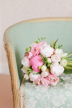 a bouquet of flowers sitting on top of a chair