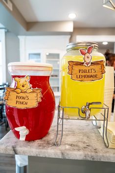 two jars with winnie the pooh labels on them sitting on a counter in a restaurant