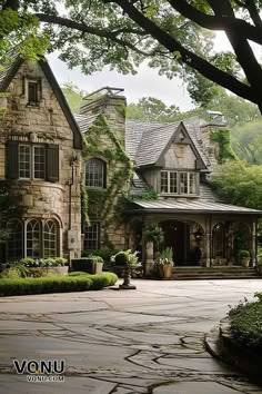 a large stone house surrounded by trees and bushes