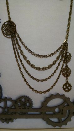 Class with Steampunk Gears Necklace Antique Bronze Open Link Chain - 4 Strands, Inside dia, 17 inches - outside dia 21 inches and 3 - 5mmX3mm, and 1 - 7mmX4mm Chains,  with a single tassel Steand 2  1/4 inch  4 Gears Antique Bronze, 1 - 25mm and 3 - 12mm                       >> with a Free Pair of closely matching Earrings <<                                          Closely matching Necklace                                                                            Lead and Cadmium Free Metal A Steam Punk Necklaces, European Gothic, Pirate Stuff, Steampunk Bracelet, Steampunk Gears, American Gothic, Gothic Steampunk, Necklace Antique, Steampunk Jewelry