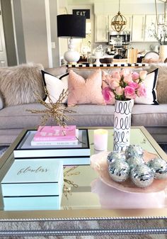 a living room filled with lots of furniture and decor on top of a glass table