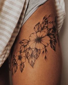 a woman's thigh with flowers on it