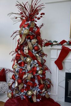 a christmas tree decorated with red and gold ornaments