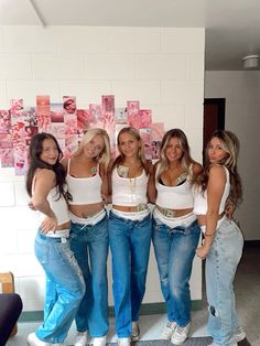 four beautiful young women standing next to each other