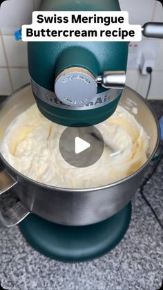 a green mixer with cream in it on top of a counter