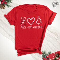 Spread the spirit of joy and harmony with our 'Peace Love Christmas Holiday Shirt'. Celebrate the magic of the holiday season with this delightful Ladies Christmas T-Shirt that embodies the essence of peace and love. Our shirt is more than just a garment; it's a symbol of unity and goodwill, making it the perfect Peace Christmas Gift for Women. Let the festive vibes fill your heart as you adorn this Merry Xmas Shirt, a cheerful addition to your holiday wardrobe. Designed with comfort and style i Peace Love Christmas, Peace Christmas, Christmas Family Shirt, Christmas Gift For Women, Perfect Peace, Xmas Shirts, Love Christmas, Family Christmas Shirts, Holiday Shirt