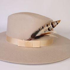 This handmade arrangement of feathers is the perfect way to set your hat apart from the rest. Simply tuck into the band of any hat. Made to order: Shipping may be delayed by 1-2 days. Includes: 1 Handmade Arrangement of Feathers. How to use: Tuck into the hat band of any hat. *Each one will vary slightly due to being handmade. *Hat not included. Adjustable Feather Hat Bands For Fall, Fall Rodeo Hat Band With Feathers, Elegant Feathered Fedora Felt Hat, Elegant Fedora Felt Hat With Feathers, Wide Brim Felt Hat With Feathers For Kentucky Derby, Flat Brim Felt Hat With Feathers For Fall, Feathered Fedora With Curved Brim For Fall, Curved Brim Fedora With Feather Trim For Kentucky Derby, Curved Brim Fedora With Feathers For Fall