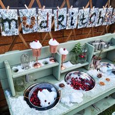 an outdoor ice cream stand with two bowls filled with cherries